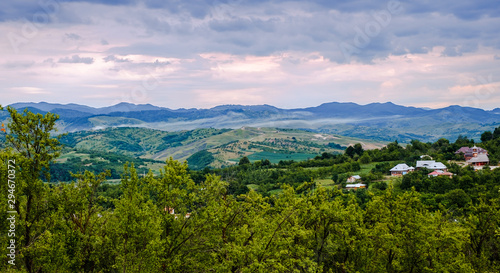 Country landscape with apple and plum orchard photo