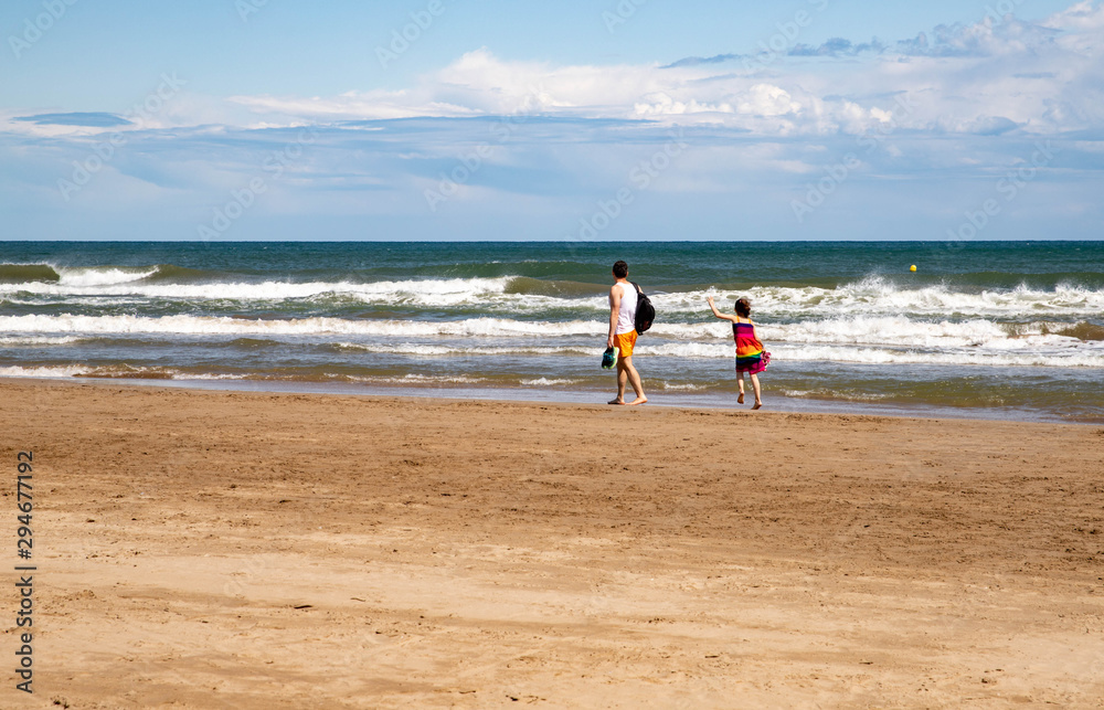 man and child by the sea