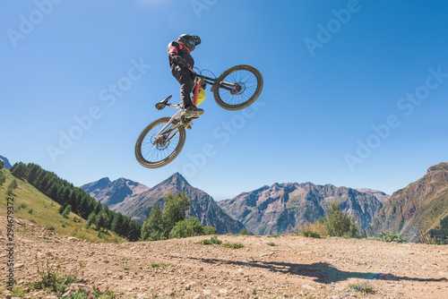 Man jumping in midair with mountain bike photo