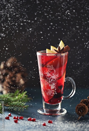 Mulled wein. Traditional christmas hot drink with fruits and spices. Dark background