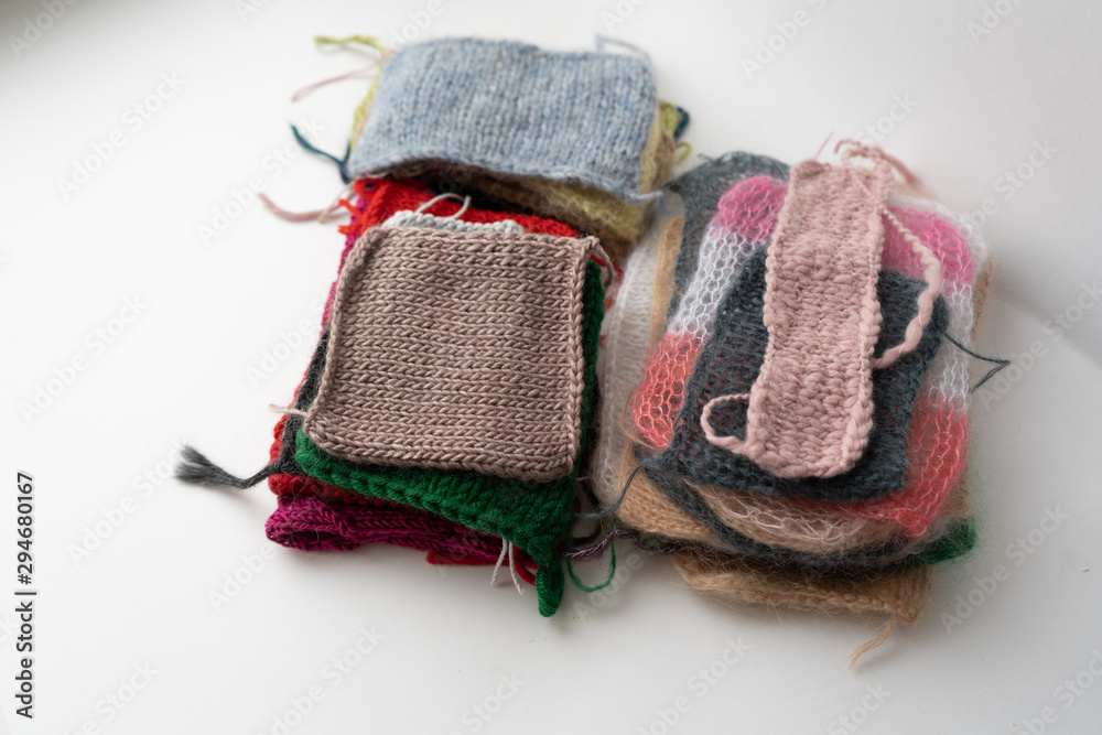 Fototapeta premium Knitted clothes on white background with copy space