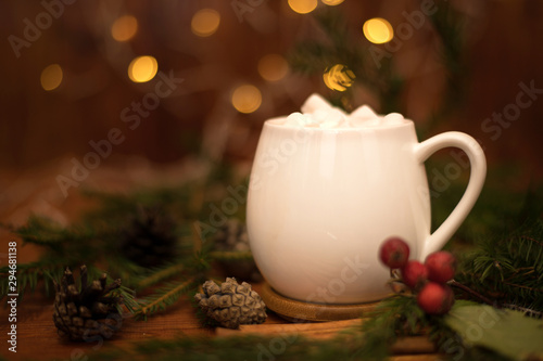 Cacao drink in a white cup with marshmallow on the background of bokeh lights, Hot Christmas drink