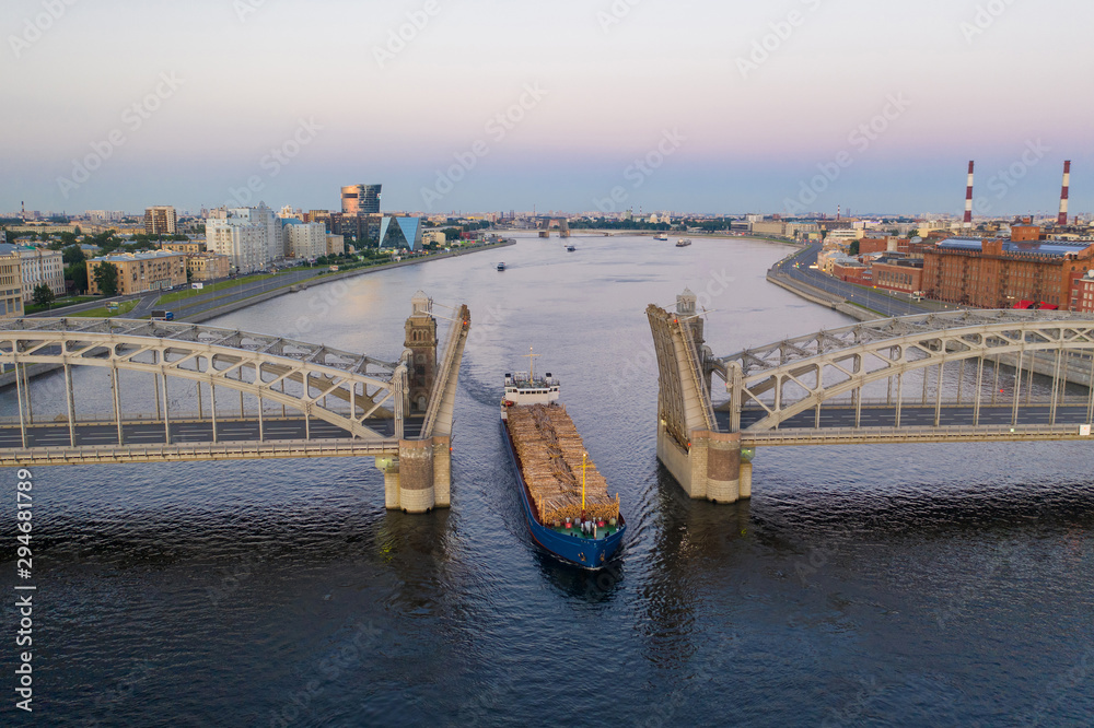 Saint Petersburg. Russia. Bolsheokhtinsky bridge lifted. Bridge of Peter the Great at sunset. The drawbridges of Petersburg. Navigation on the Neva River. Cities of Russia. Panorama of St. Petersburg.