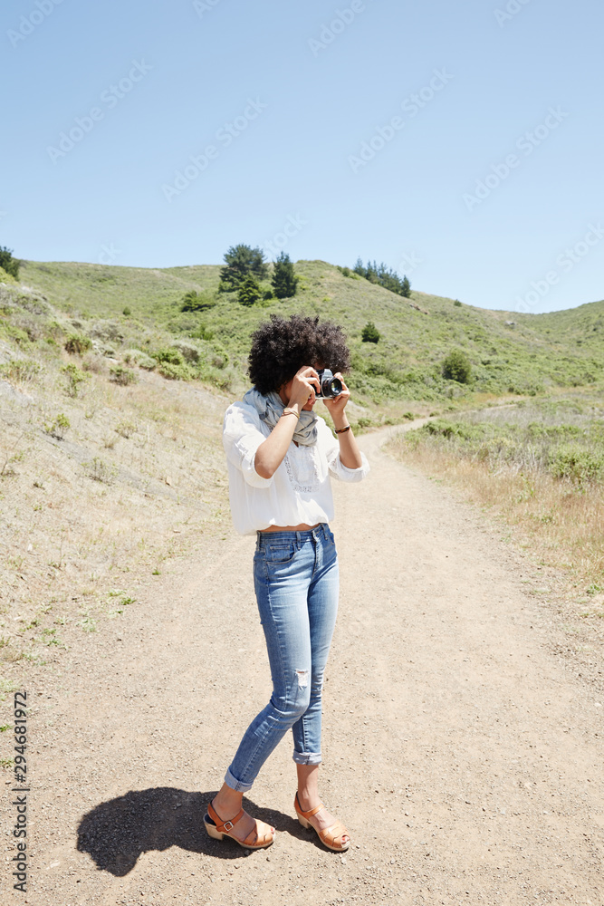 African American woman taking a photo in nature African American woman taking a photo in nature