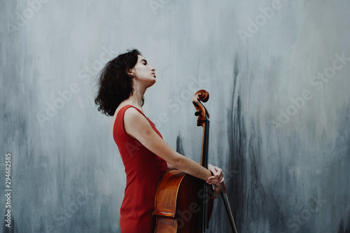 Young woman with cello instrument photo