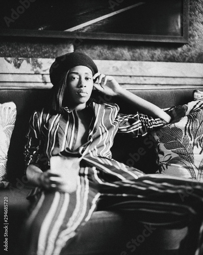 Easygoing Fashionable Young African American Woman Relaxed on Sofa photo