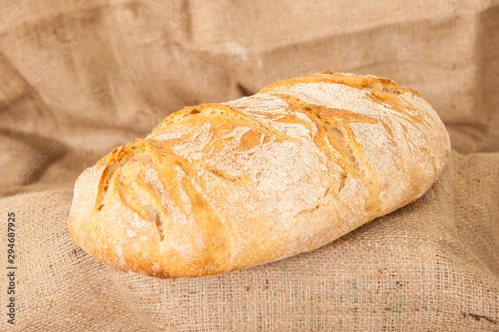 white bread on burlap background