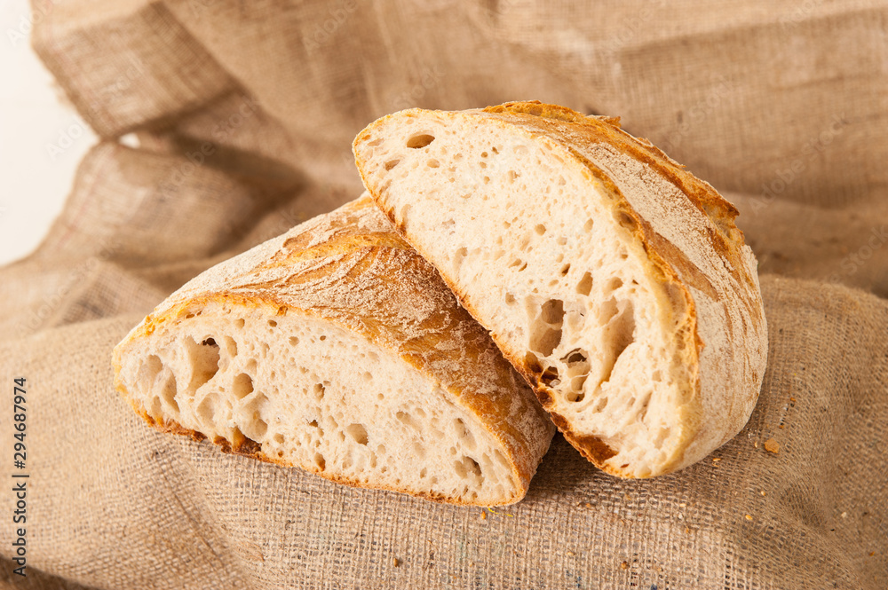 Naklejka premium white bread on burlap background