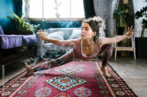 Woman doing yoga in living room photo
