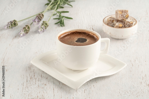 A cup of Turkish coffee and delight on a wooden table