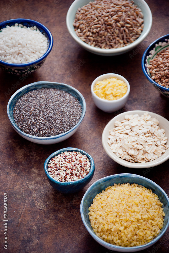 Various organic cereals and grains in different bowls Various organic cereals and grains in different bowls