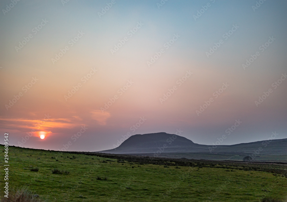 Red sky sunsetting behind Slemish mountain, County Antrim, Northern Ireland