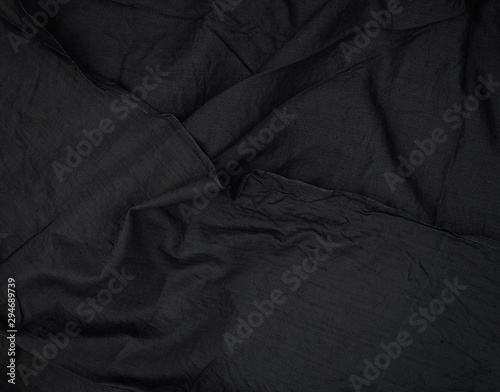 fragment of black cotton fabric with waves, full frame © nndanko
