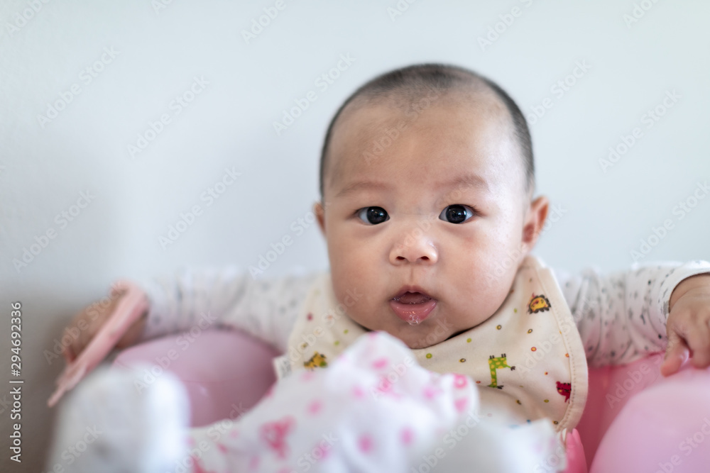 Little 4 months baby playing with toys at home