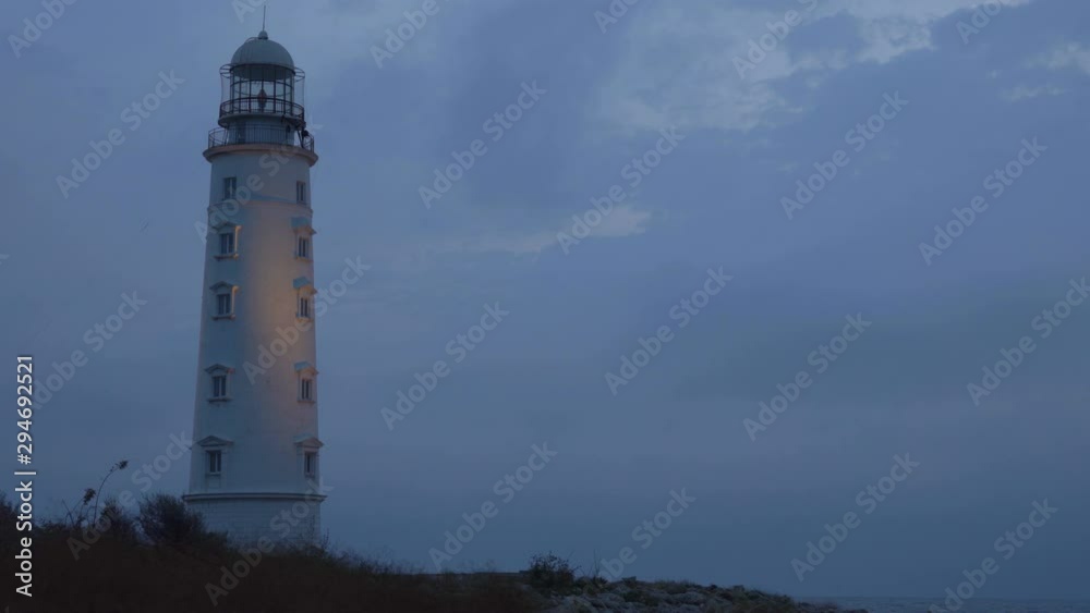 Picturesque white lighthouse at the dusk time. 4k footage. Picturesque white lighthouse at the dusk time. 4k footage.