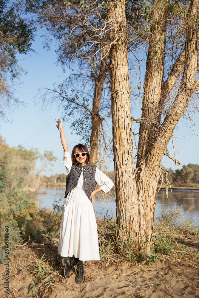 A lively girl under the populus euphratica A lively girl under the populus euphratica