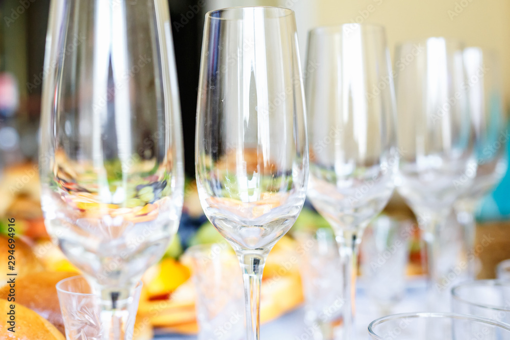Banquet table served with instruments and decorated with empty wine glasses Banquet table served with instruments and decorated with empty wine glasses