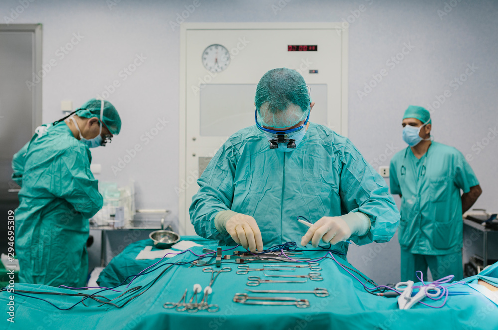 Surgeons in the operating room preparing the tools Surgeons in the operating room preparing the tools