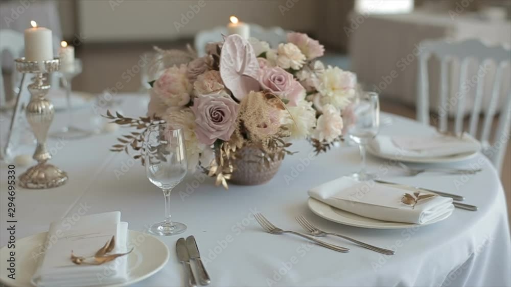 Close up of elegant, decorated table prepared for a luxury dinner. Dcorated table for a wedding dinner with burning candles Close up of elegant, decorated table prepared for a luxury dinner. Dcorated table for a wedding dinner with burning candles