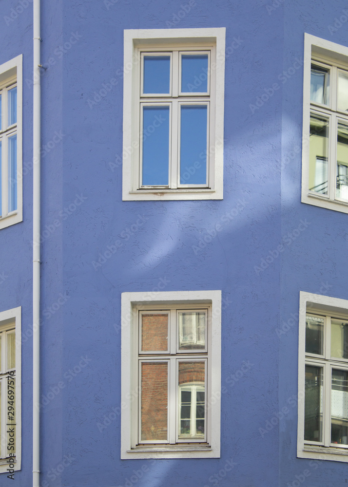 White windows in blue wall.