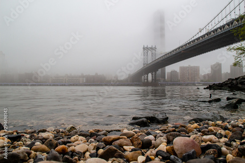 Manhattan Bridge covered by fog view from East-River promenade © Dmitriy