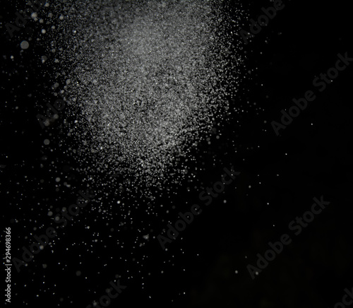 White snow falls on a black sky background. Photo of snow on a dark background