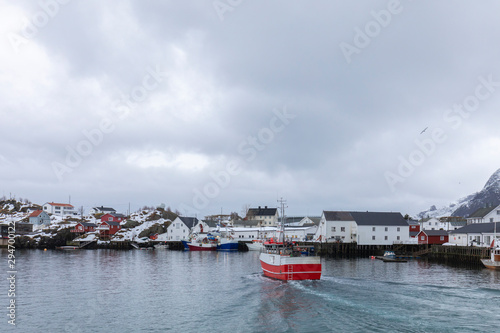 A fishing boat arrives at a small port in Norway photo