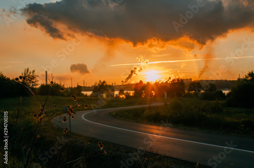 city sunset in front of pipes with smoke