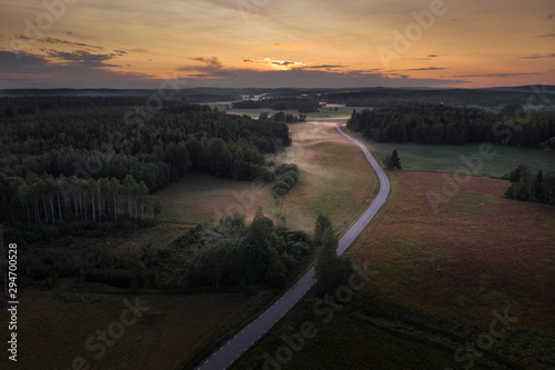 Aerial view of foggy rural fields at sunset