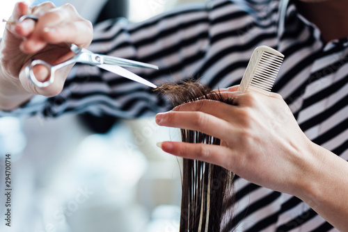 Hairdresser cutting hair in hair salon photo