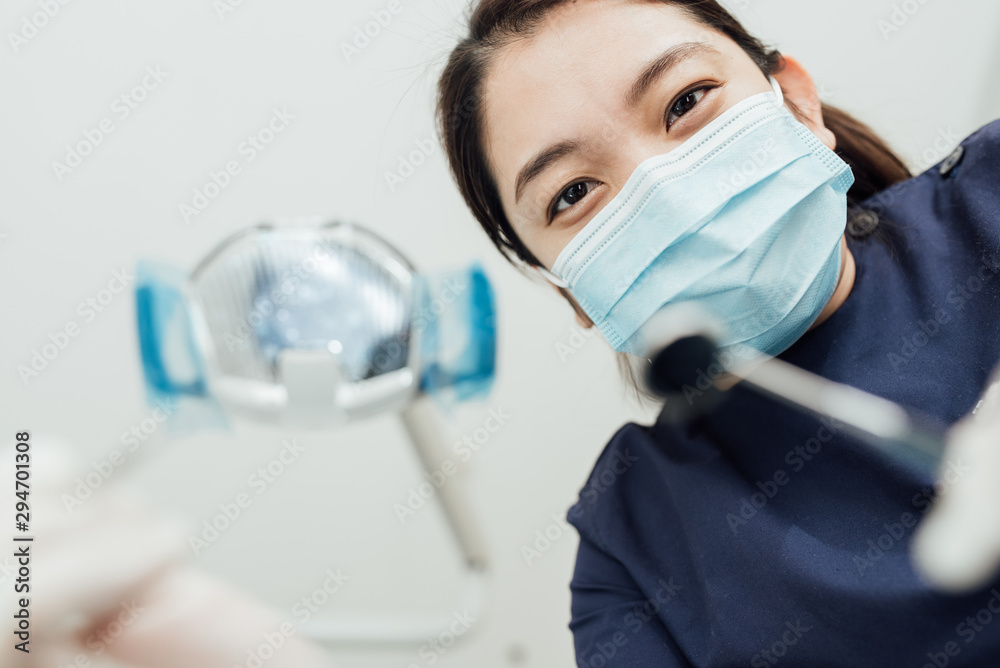 Personal perspective of female dentist with mask at work Personal perspective of female dentist with mask at work