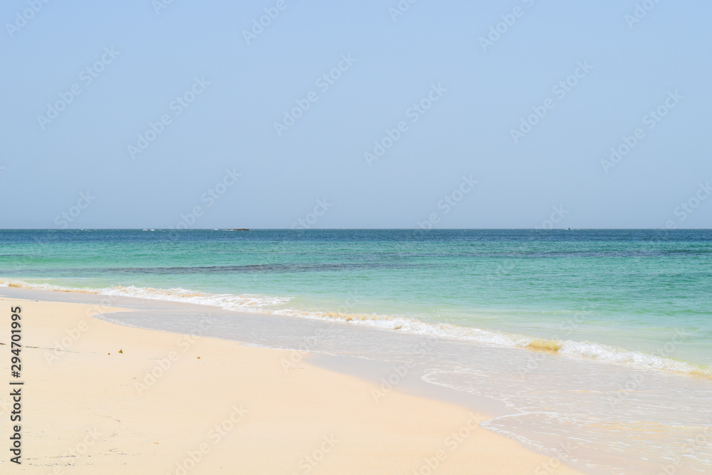 View from beach over the ocean, white sand and turquoise water, cayo levantado in the caribbean sea