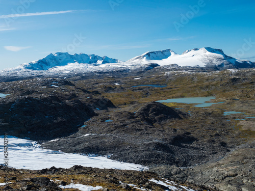 Panoramic view from Krossbu on glacier Smorstabbreen, snow-capped mountains and blue lakes in Jotunheimen National Park, Western Norway photo