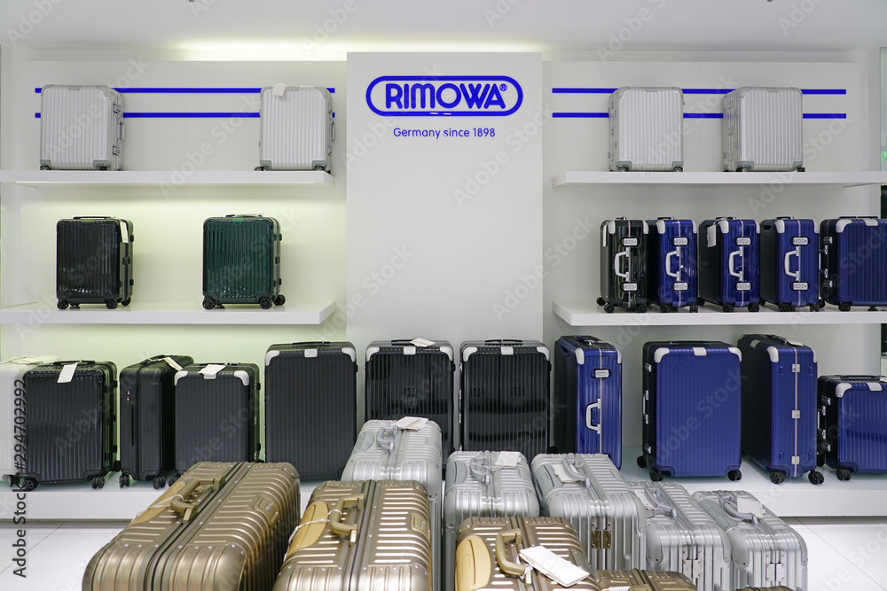 XIAMEN, CHINA -16 JUN 2019- Display of colorful metal suitcases in a Rimowa  store. Rimowa is a German company known for its sturdy aluminum and  polycarbonate sturdy carry-on luggage. Stock Photo