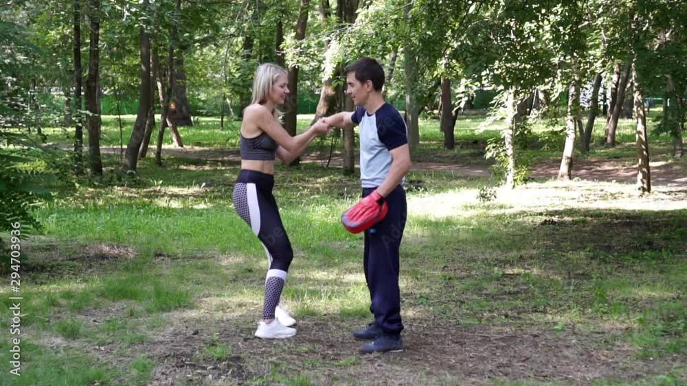 A woman trains martial arts techniques. Women's self-defense. A woman trains martial arts techniques. Women's self-defense.
