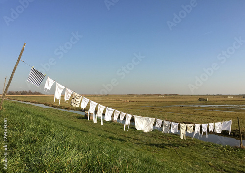Clothes drying on clothes line over field