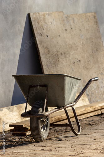 Wheel barrow on construction site photo