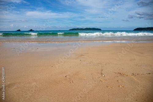 Fototapeta Naklejka Na Ścianę i Meble -  Beach sand and sea wave perspective view. Idyllic seashore with white sand beach. Tropical vacation on exotic island