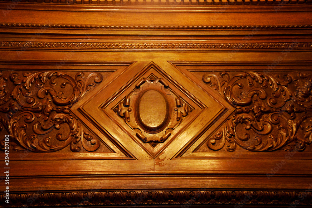 Part of a wood carving pattern. A mahogany pattern adorns the furniture.