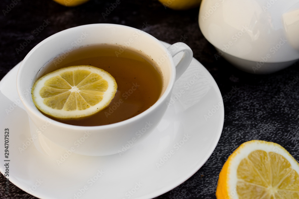 Teapot and cup of tea with fresh lemon. Teapot and cup of tea with fresh lemon.
