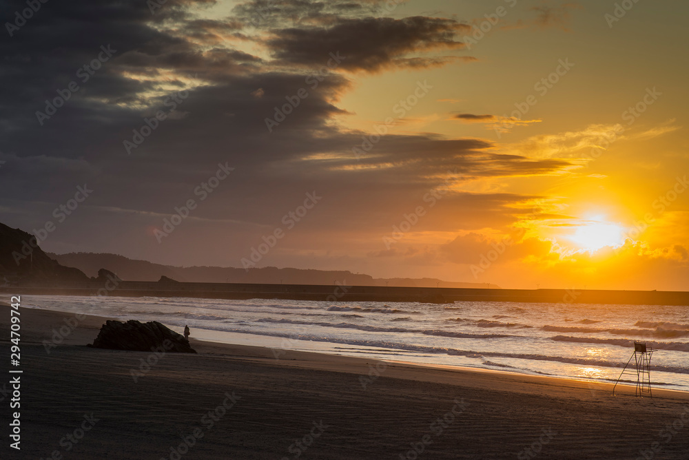 Obraz premium Sunset on Asturias beach. Clouds over the Cantabrian Sea