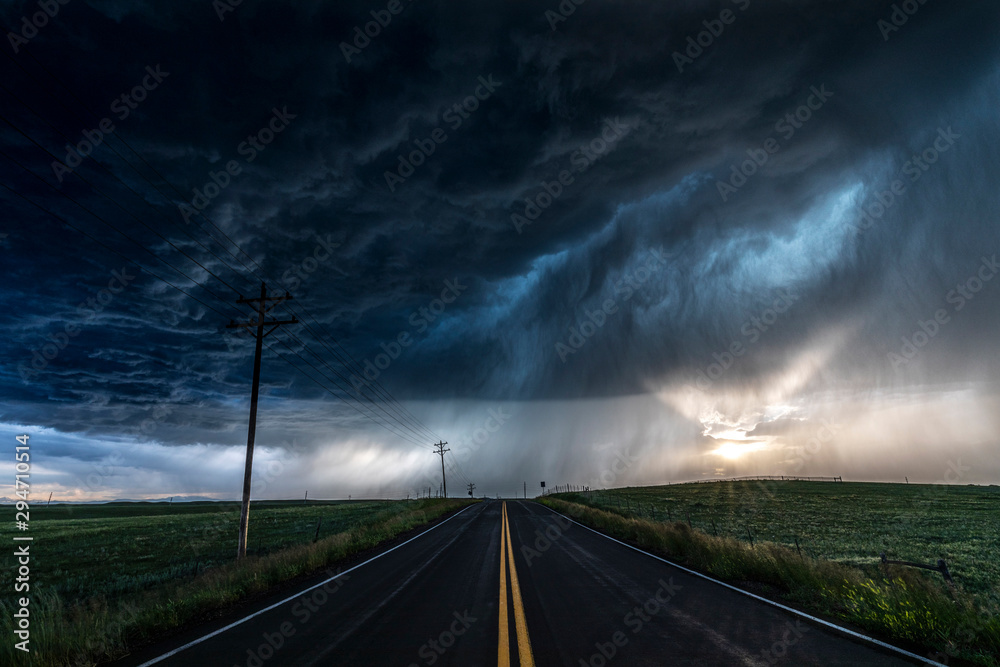 © Cavan Images - Heavy storm and rain with road and green fields