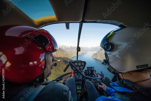 Flight instructor teaching student pilot how to fly a helicopter