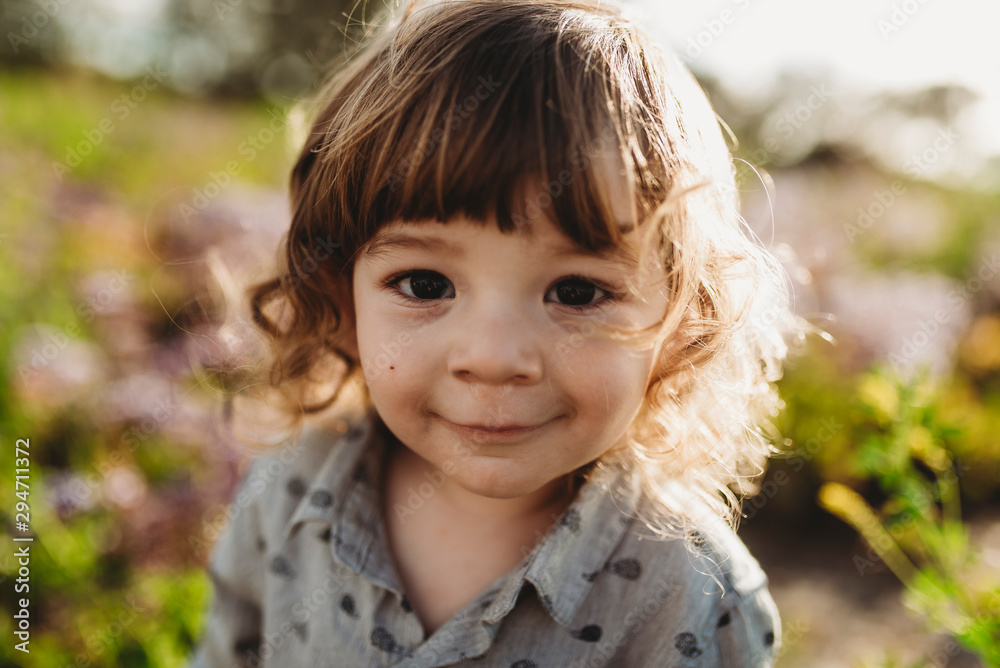 Close up portrait of little boy smiling in backlight Close up portrait of little boy smiling in backlight