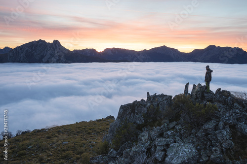 Man observe mists at sunrise from the top of mountains, Spain photo