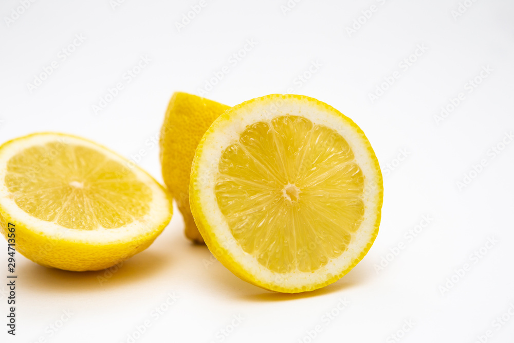 Freshly cut lemon. Sliced lemon on white background. Freshly cut lemon. Sliced lemon on white background.