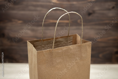 An opened craft bag stands on a table on a wooden background. ecologically pure. place for text. Many craft packages close up. Business concept
