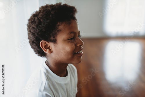 Portrait of smiling school-aged boy looking to side photo