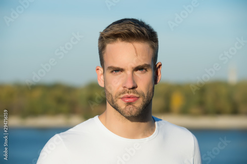Male beauty standards. Handsome man stylish hairstyle. Handsome caucasian man looking at camera nature background. Ideal traits that make man physically attractive. Bearded guy casual style close up