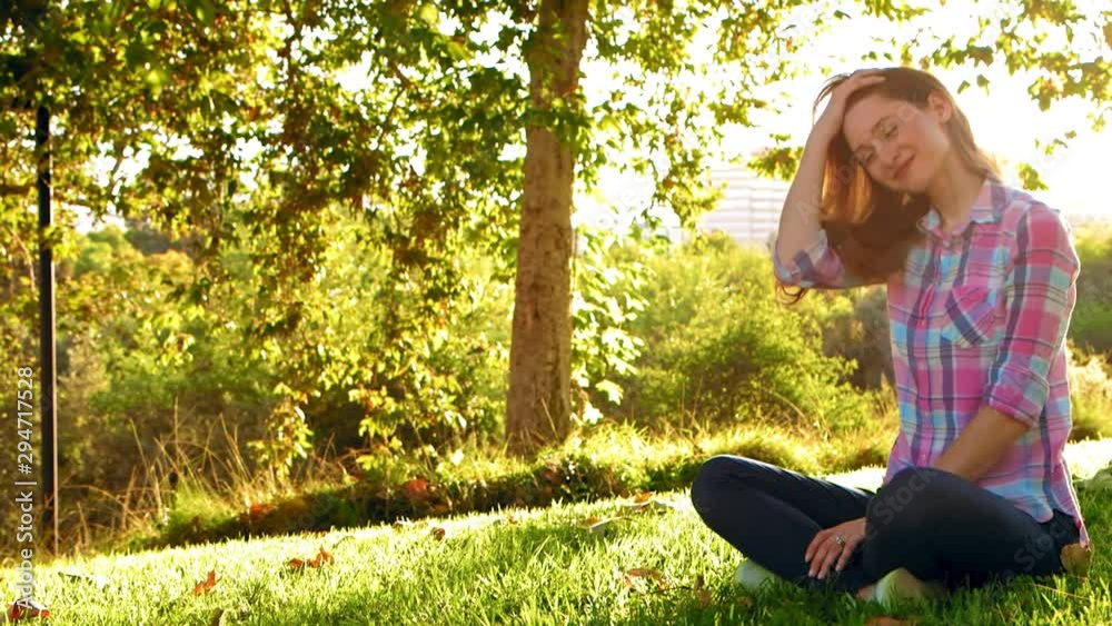 Woman Sitting and Smiling at Peace With Life at Park